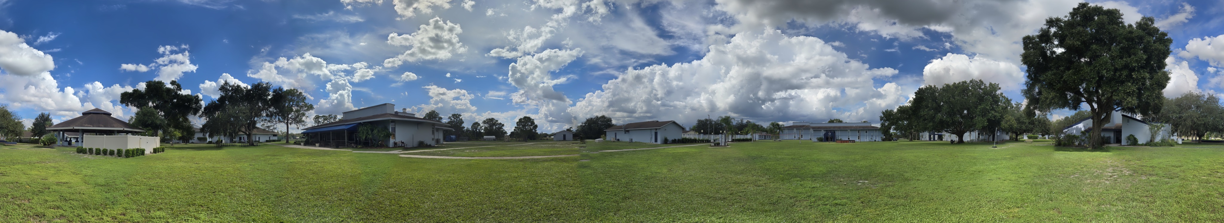 Wide panoramic view of the Camp Frontier Outdoor Games area with sky and lawn